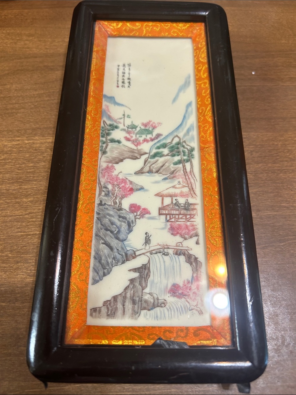 9” x 4” framed art on white bisque or ivory (not sure)  it is hand painted.